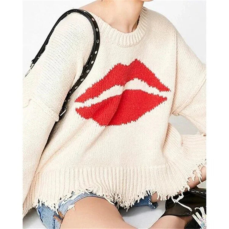 Women's oversized cropped chunky knit wool sweater in neutral tones with lip motif and fringed hem