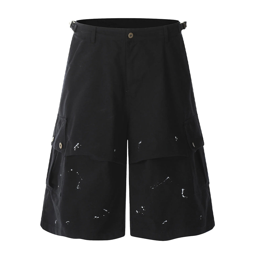 Oversized cargo shorts with splattered paint details, wide-leg cut, calf length, multi-pocket distressed fade