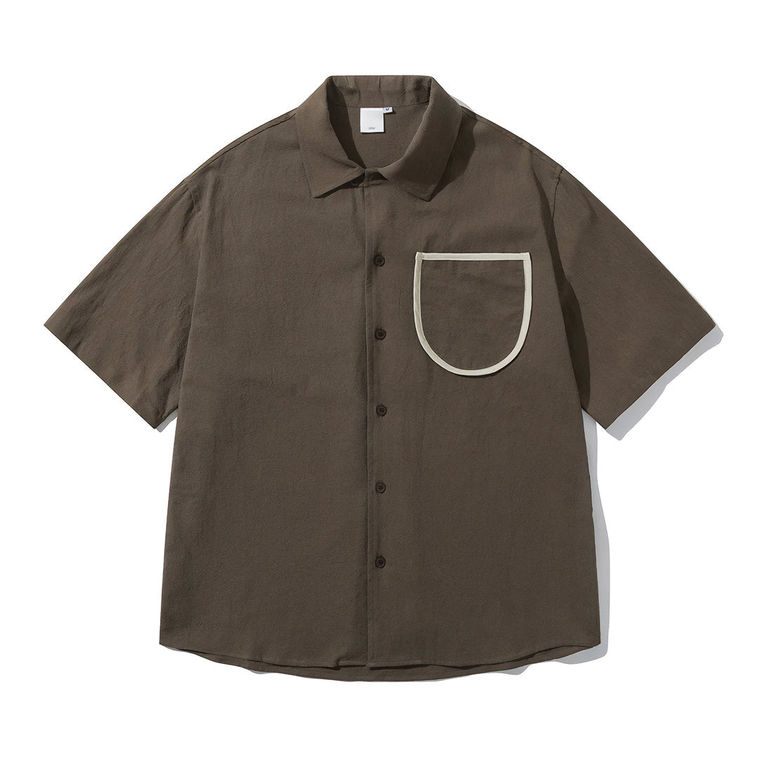 White cotton camp-collar shirt with contrast chest pocket, loose fit, button closure