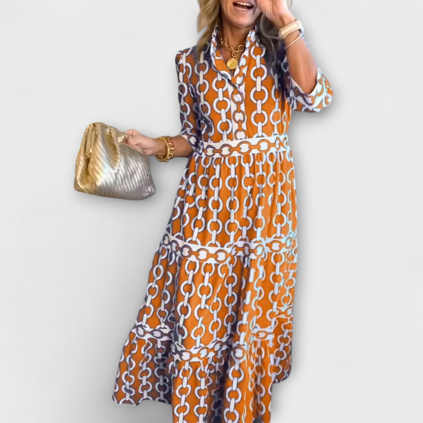 Elegant midi dress with chain pattern, tiered skirt, three-quarter sleeves, and smoothing waistline