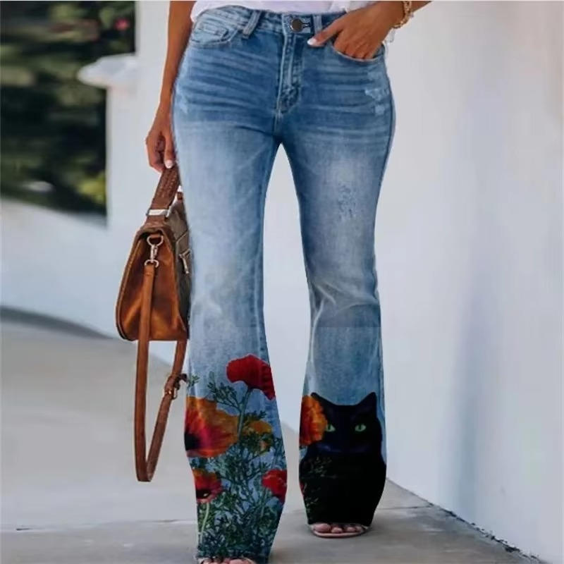 Women's high waist flare jeans with botanical floral print blooming across the flared denim hem