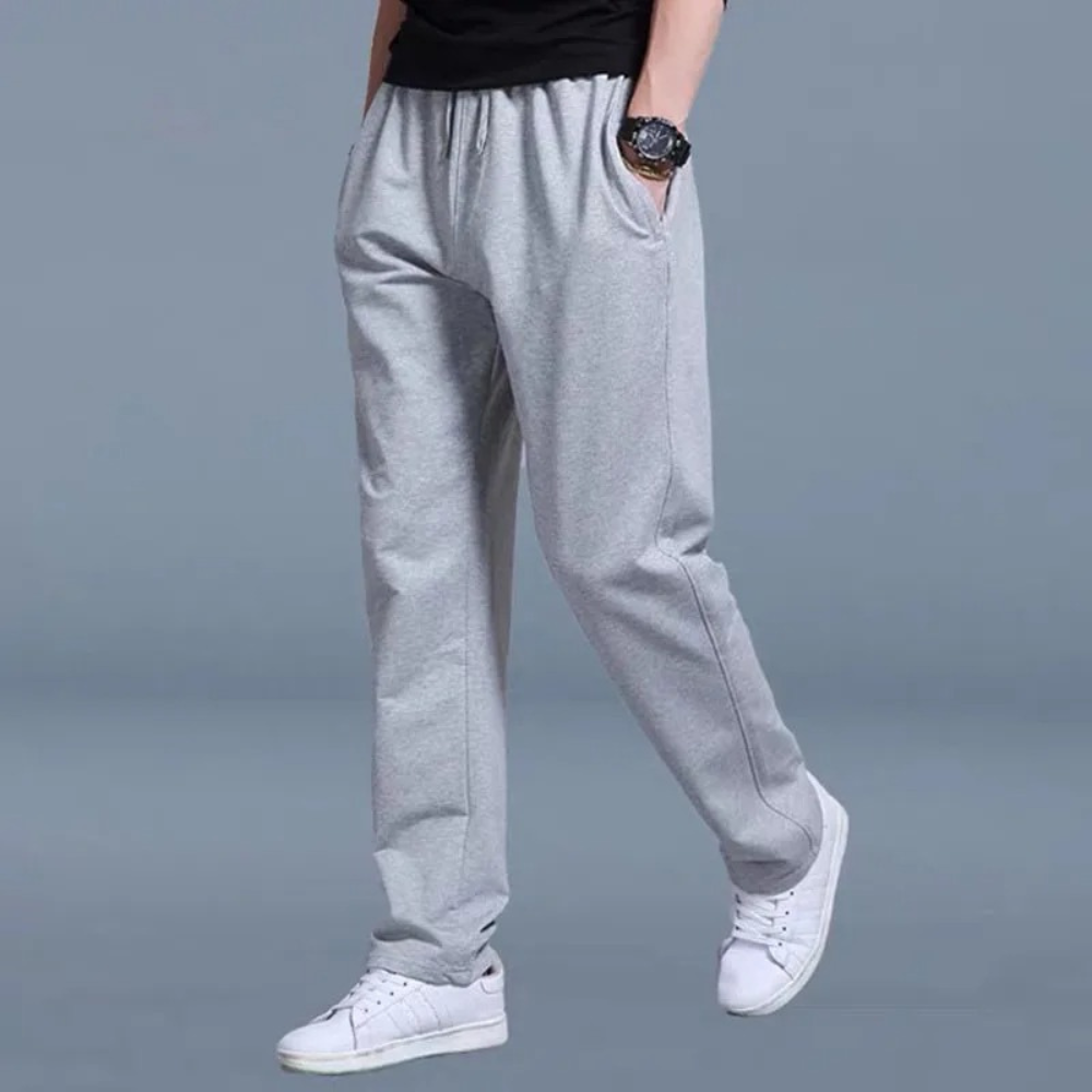 Men's gray relaxed-fit jogger pants with elastic waistband, drawstring, and side pockets