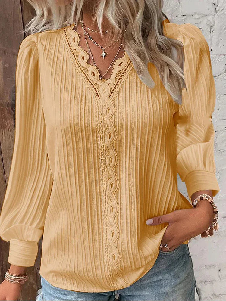 Ivory chiffon blouse with intricate lace neckline accents and relaxed feminine fit