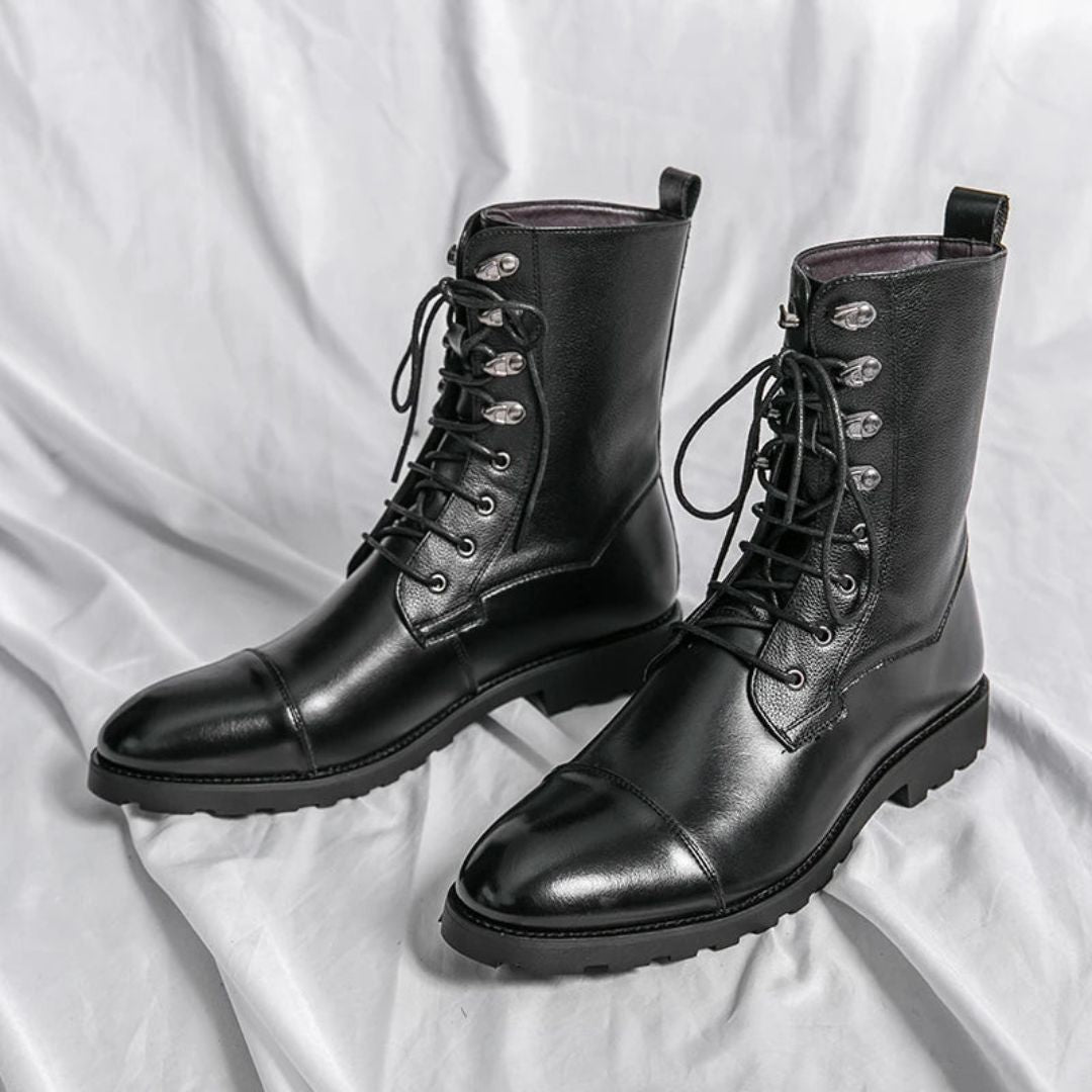 Black full-grain leather cap-toe boots with reinforced metal hooks and heavy-duty outsole