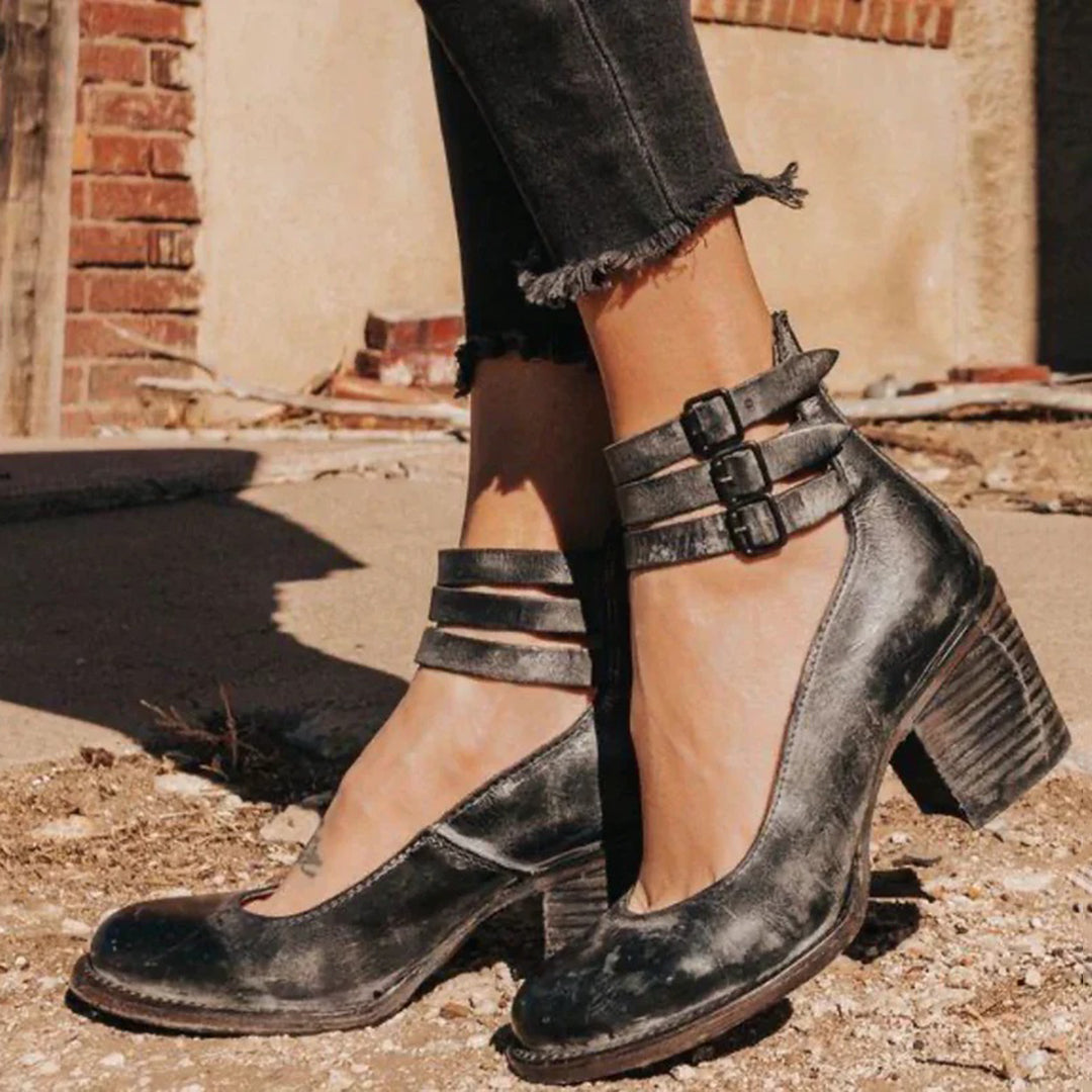 Women's closed-toe block heel pumps with adjustable ankle strap in elegant synthetic leather finish