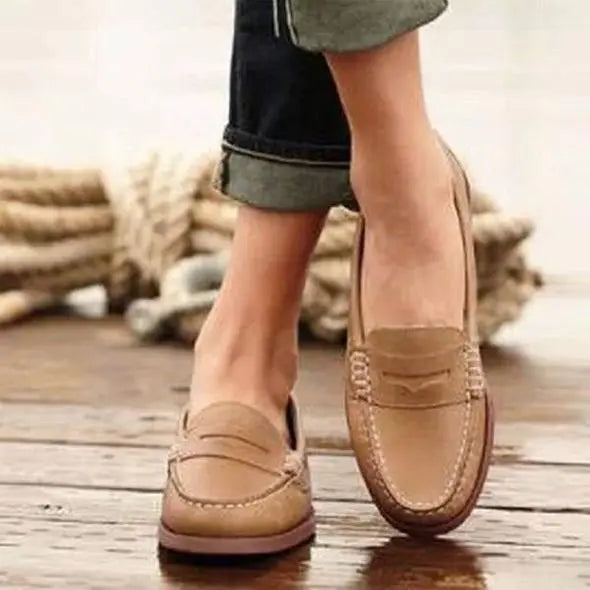 Women's classic brown penny loafers slip-on moccasin-inspired style with iconic coin slot detail
