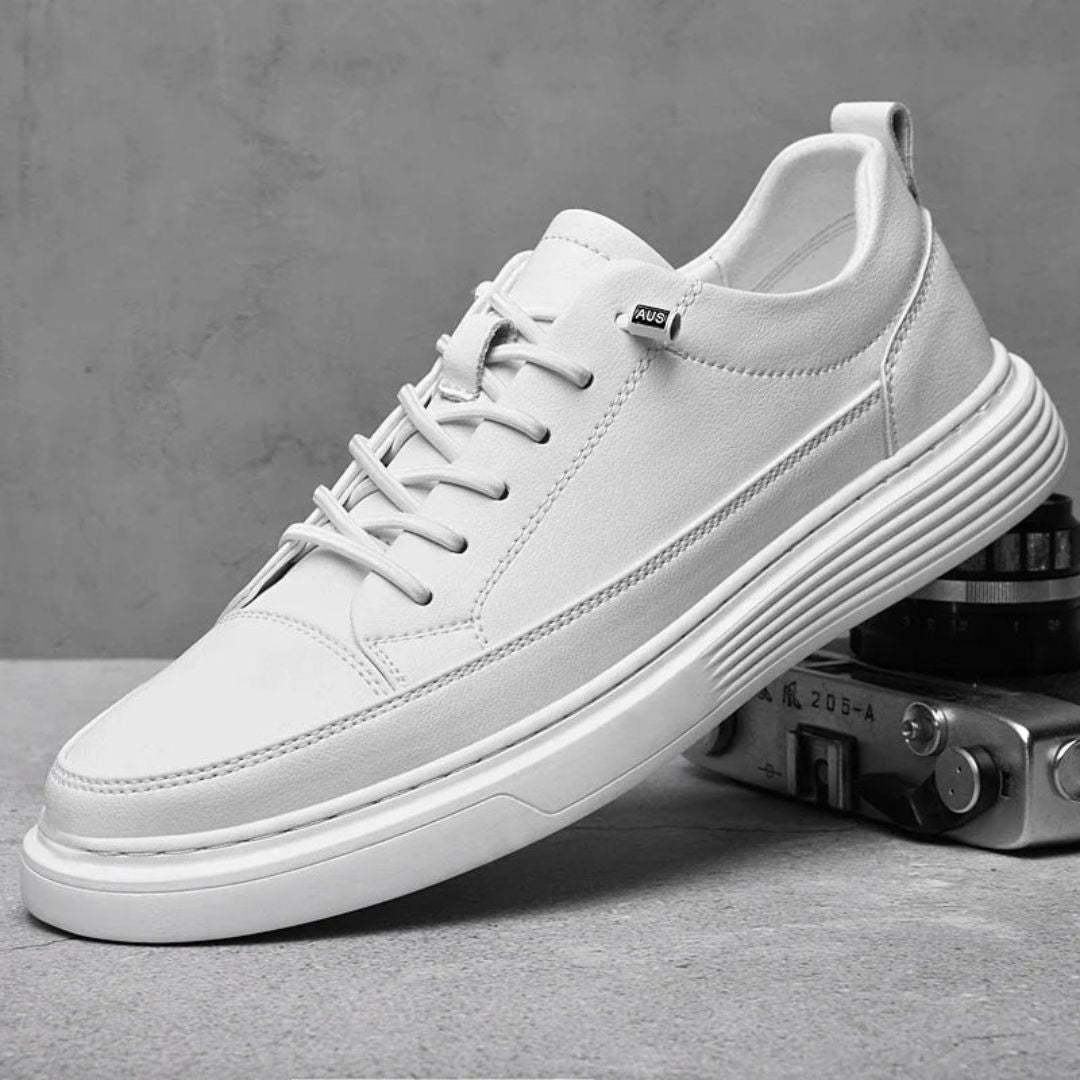 White minimalist sneakers with cushioned insole, clean urban silhouette and flexible rubber outsole