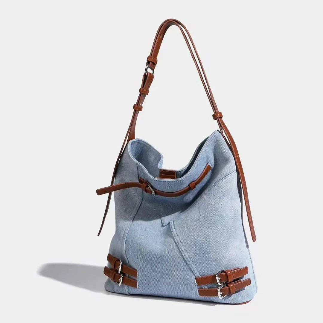 Everyday denim carryall bag with faux leather accents, versatile relaxed-polished style for daily use