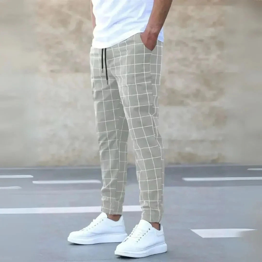Men's checkered tapered jogger pants in classic black and white pattern with ribbed cuffs