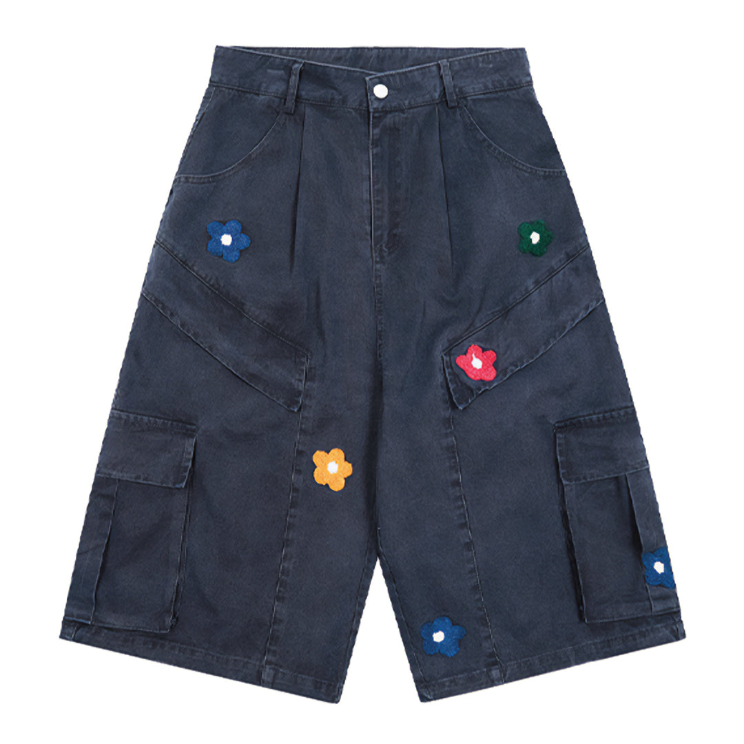 Blue cotton denim wide-leg cargo shorts with pleated front and colorful knitted flower patches