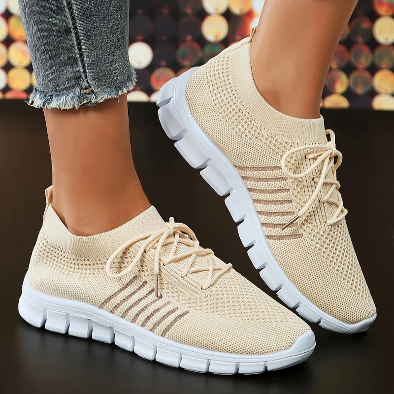 Women's white lightweight athletic sneakers with breathable mesh upper and feather-light casual design