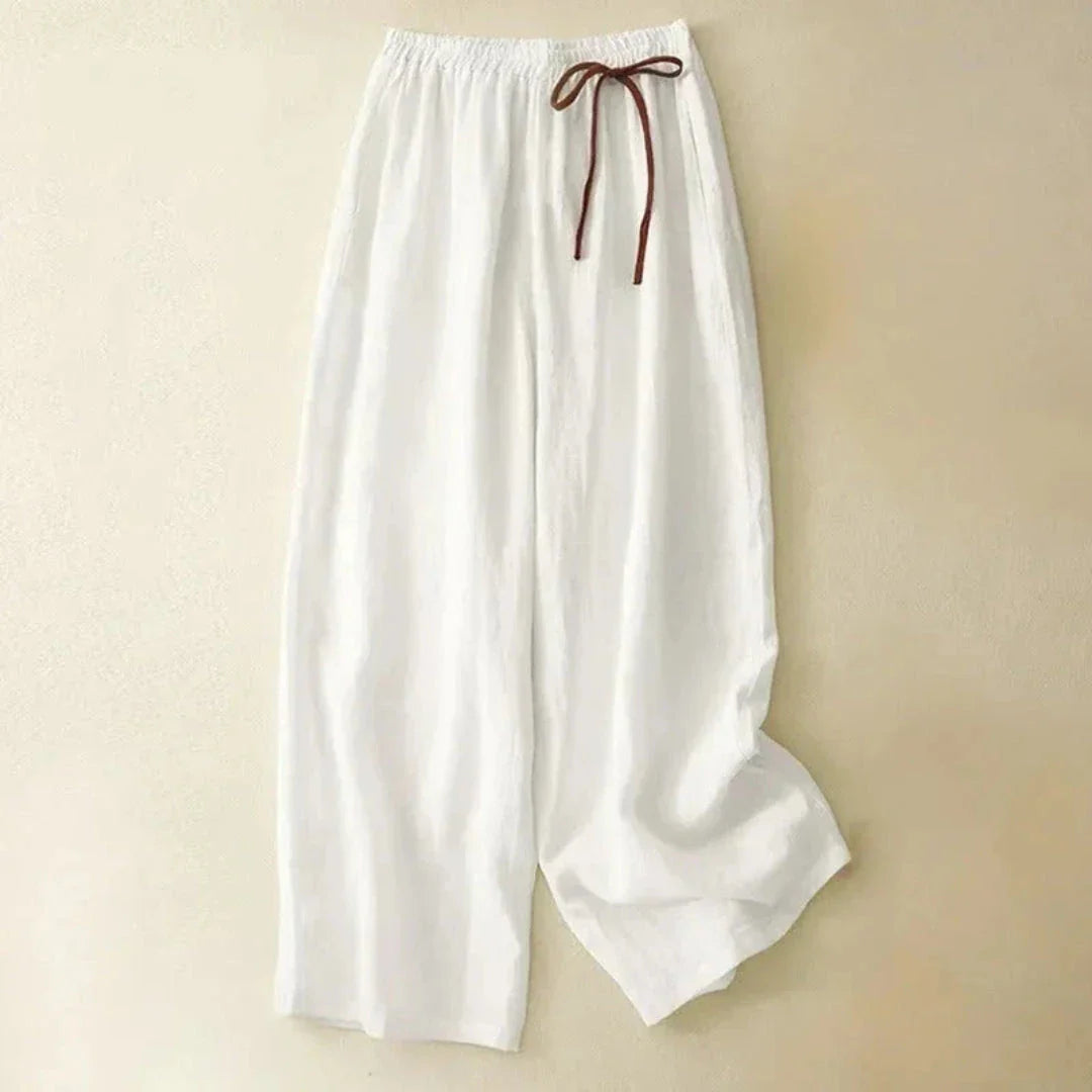 Beige wide-leg linen trousers with drawstring waist, relaxed mid-rise fit and breezy silhouette
