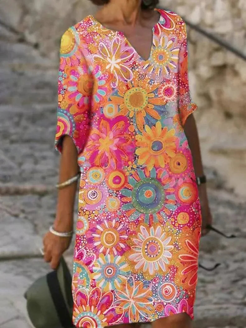 Women's floral flowy elegant dress with feminine waist shaping and flowing skirt silhouette