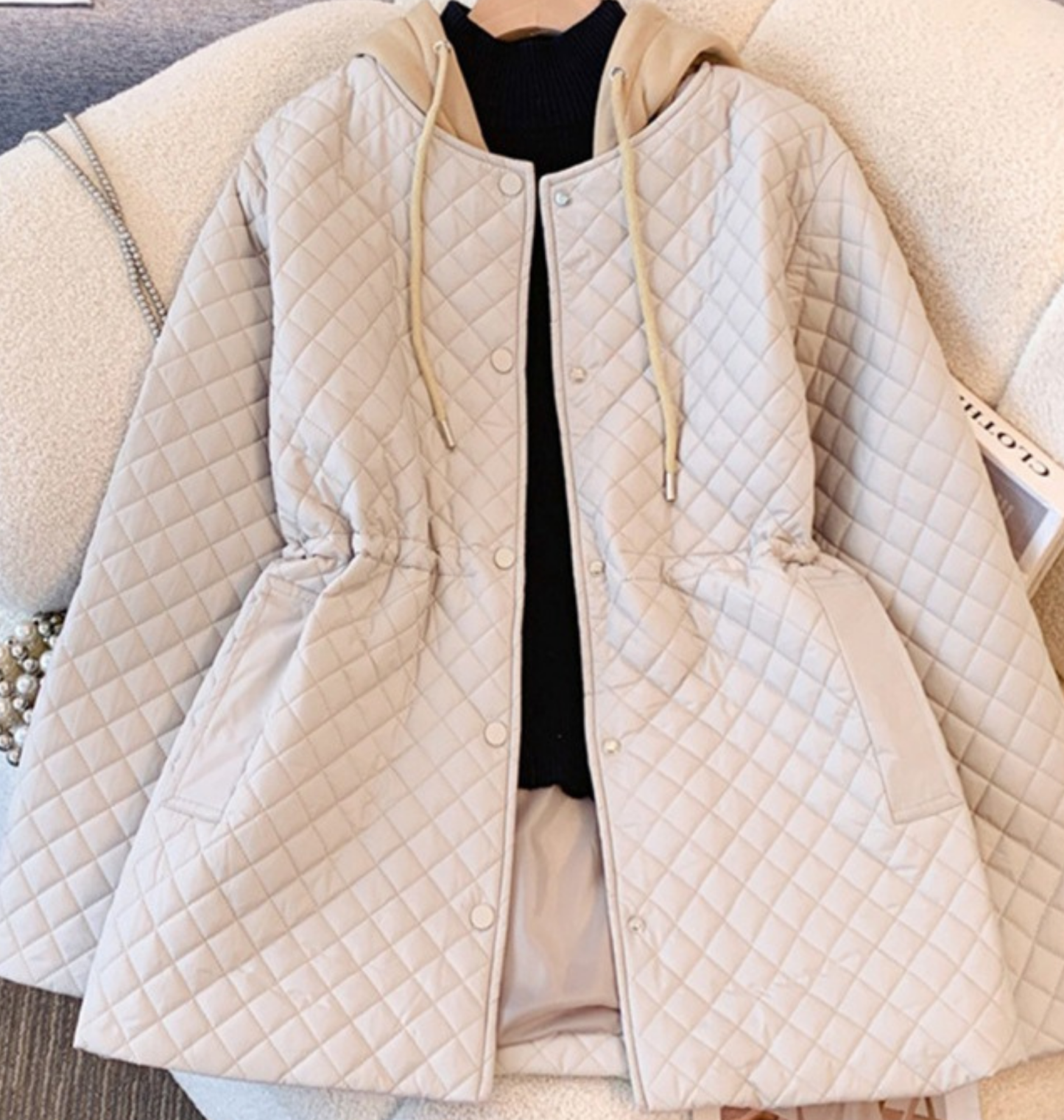 Women's black quilted nylon hooded coat with drawstring waist and snap button closure