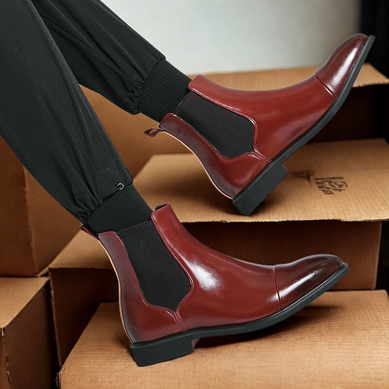 Men's black leather Chelsea ankle boots with elastic side gussets, sleek classic dress silhouette