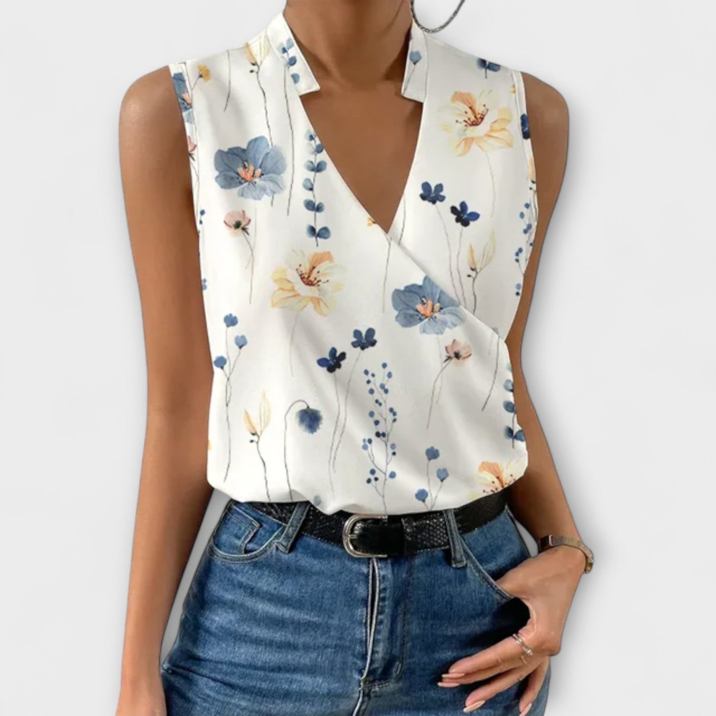 Women's sleeveless white wrap V-neck blouse with collared crossover drape, polished chic style