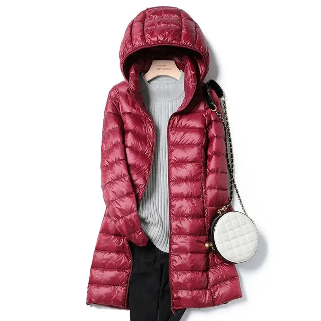 Women's black longline hooded puffer coat with quilted finish and wind-resistant full zip