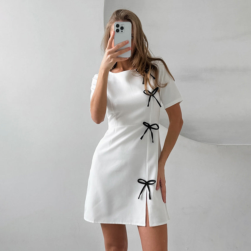 Women's mini A-line dress with short sleeves, round neck, and bow details for feminine everyday style