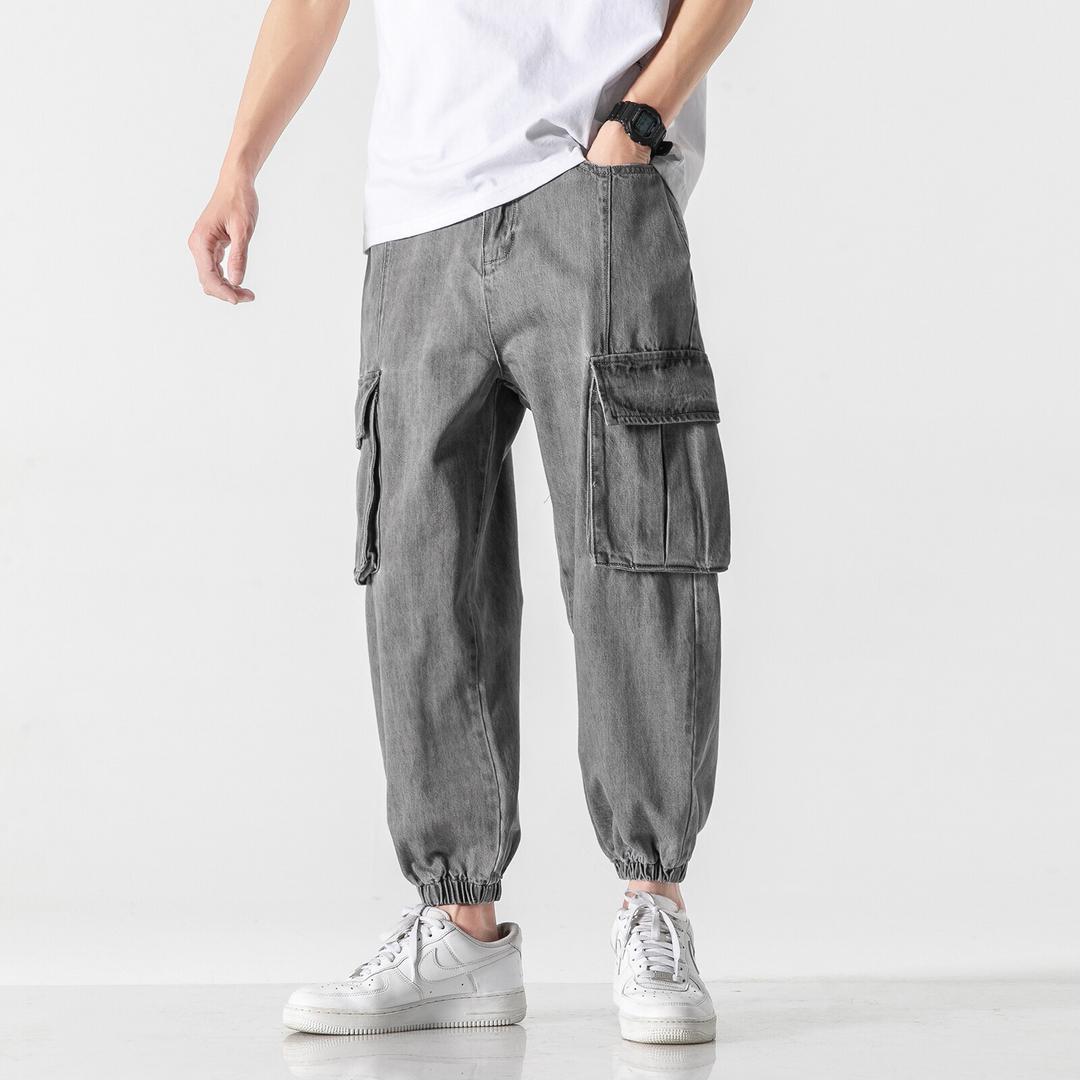 Washed grey denim cargo pants tapered jogger cut with elastic cuffs and dual cargo pockets