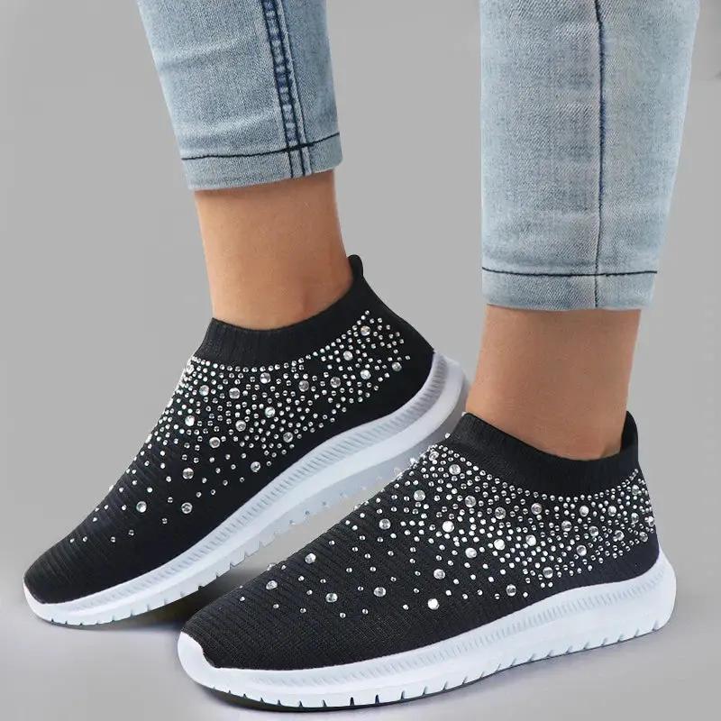 Women's white rhinestone slip-on sneakers with breathable knit upper and sparkling embellishments