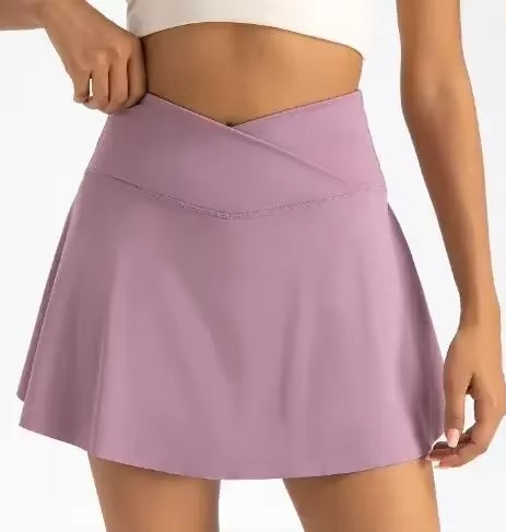 White high-waist tennis skirt with built-in compression shorts and side pockets