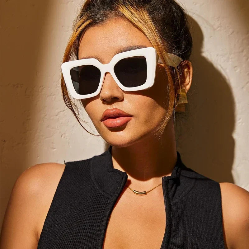 Black oversized vintage sunglasses with high-gloss acetate frame and UV-protective tinted lenses