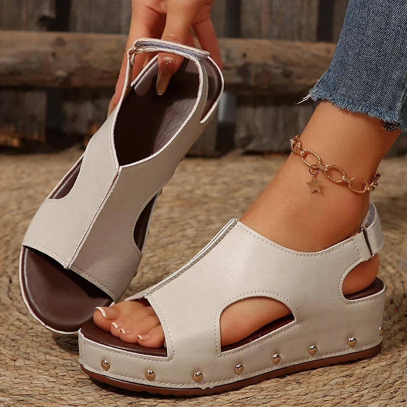 Women's platform cushioned sandals in neutral tones with elevated sole and padded footbed
