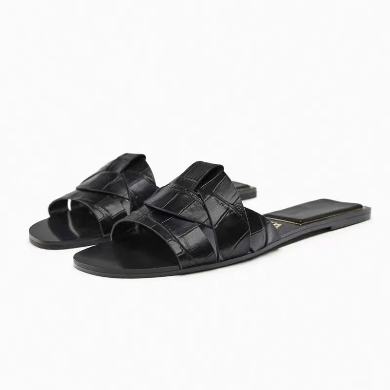 Women's cushioned flat slides with smooth minimalist straps in a lightweight versatile silhouette