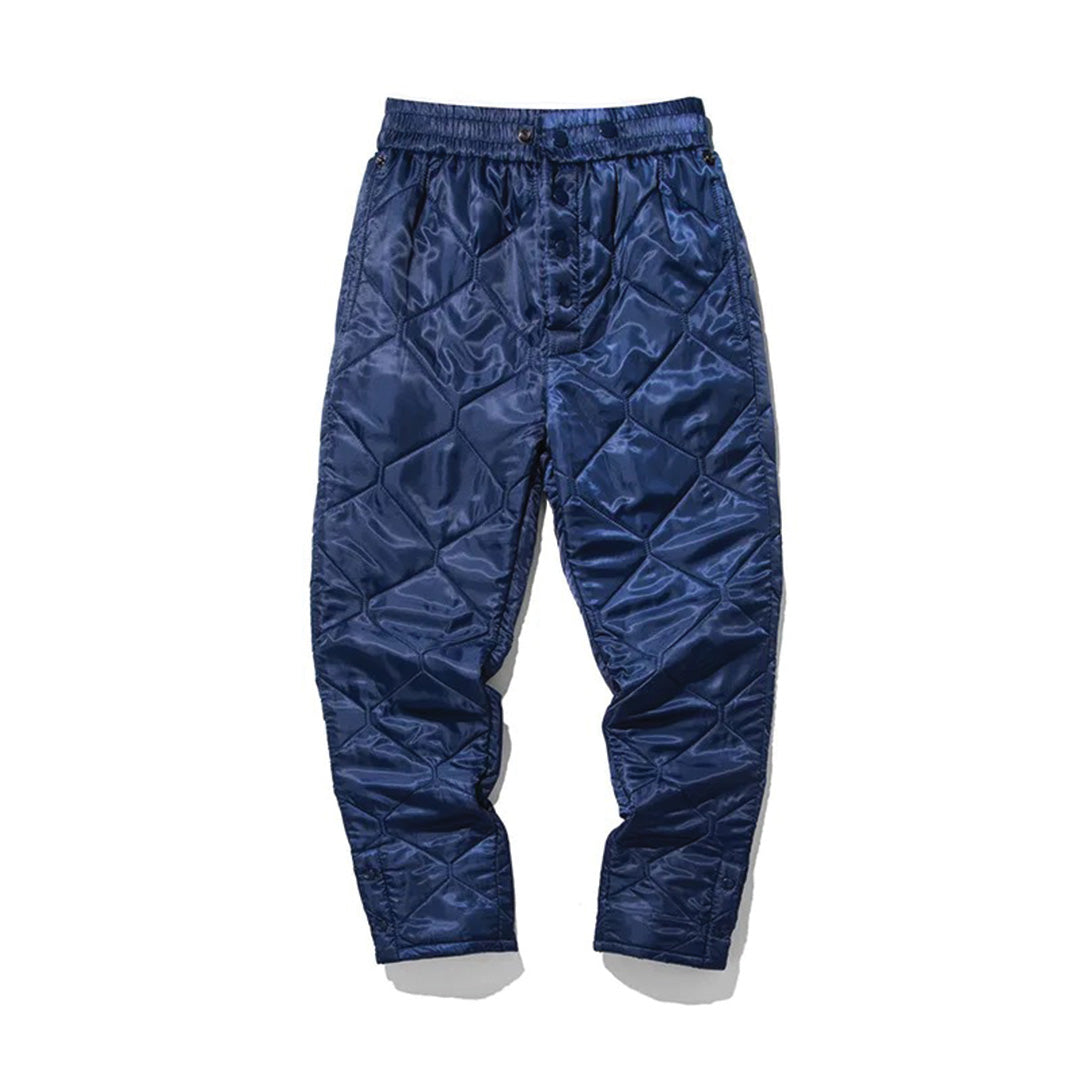 Men's diamond-quilted trekking pants in neutral tone with elastic waist and button fly closure