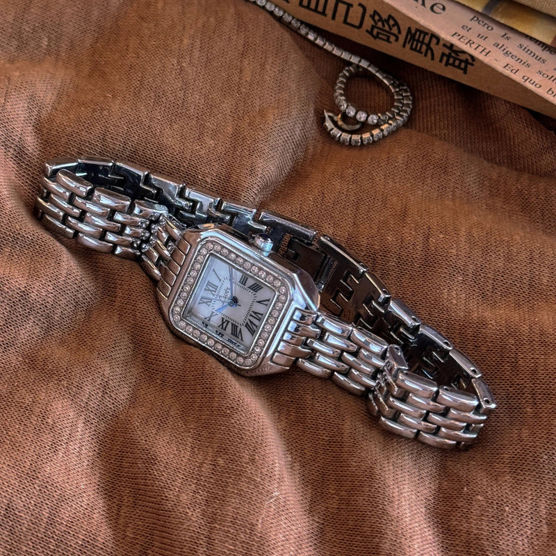 Valencia wrist watch with rhinestone studs, vintage gold chain, Roman dial, and blue hands