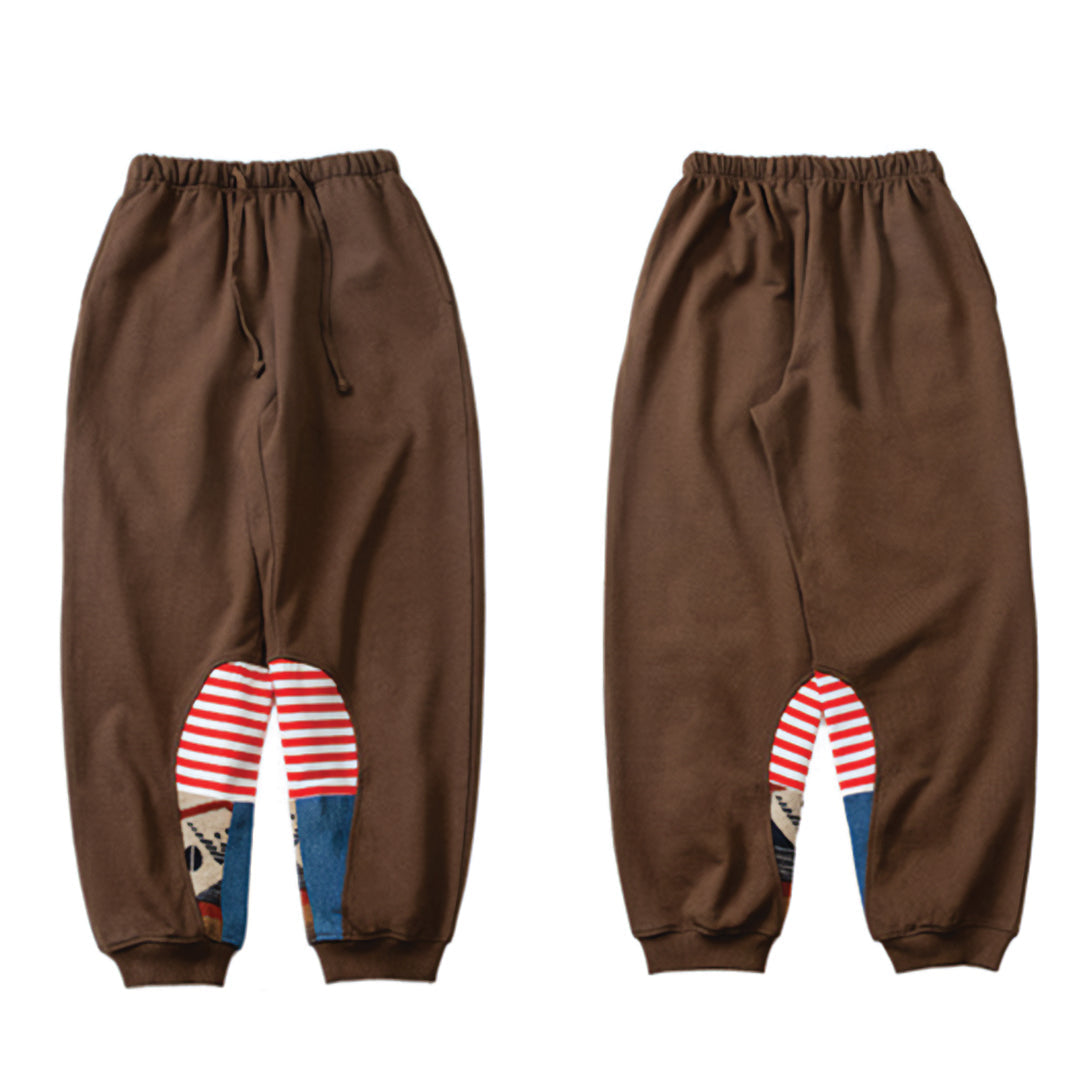 Loose-fit black cotton terry sweatpants with stripes and dots patchwork design, elastic waist