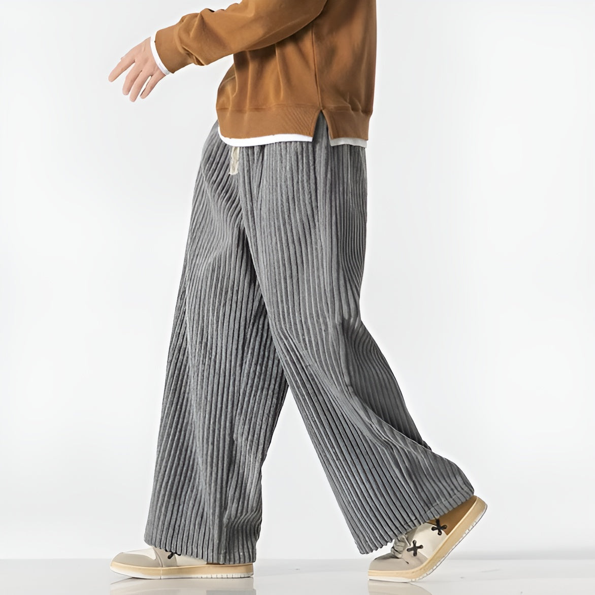 Relaxed corduroy pants with densely ribbed texture, elastic drawstring waist, and casual wide-leg fit