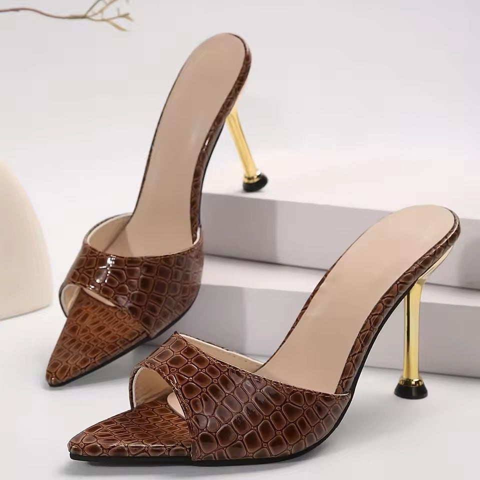 Black croc-embossed vegan leather stilettos with glossy patent sheen and pointy peep-toe design