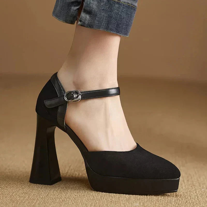 Women's black platform block heel pumps with ankle strap, rounded toe, and high heel for elegant lift