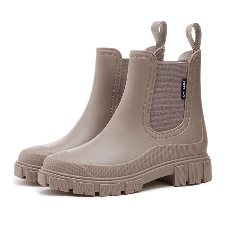 Women's black Chelsea-style waterproof rain boots with elastic side panels for easy slip-on wear