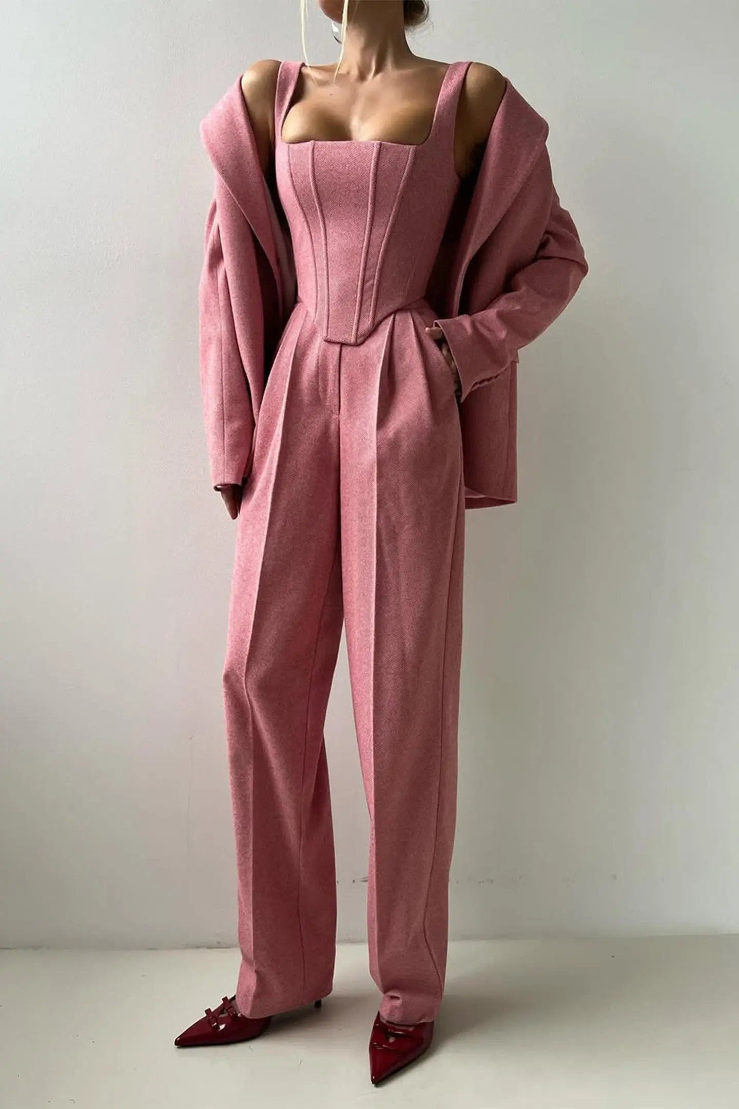 Women's tailored three-piece navy pant suit set with structured blazer, bustier top, wide-leg trousers