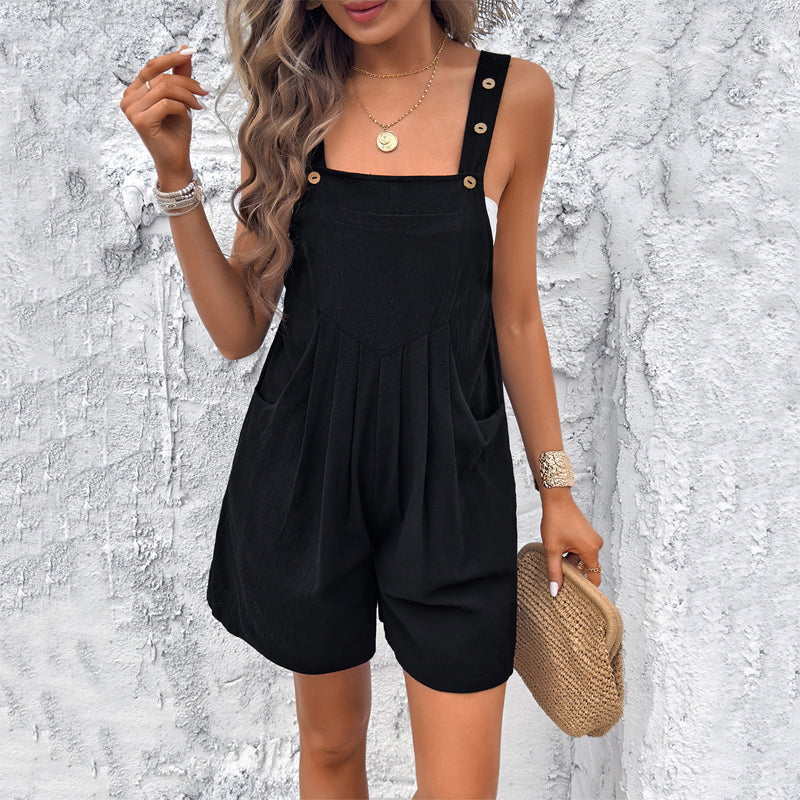 Women's fluid draped short jumpsuit with adjustable buttoned straps, soft pleats, and side pockets
