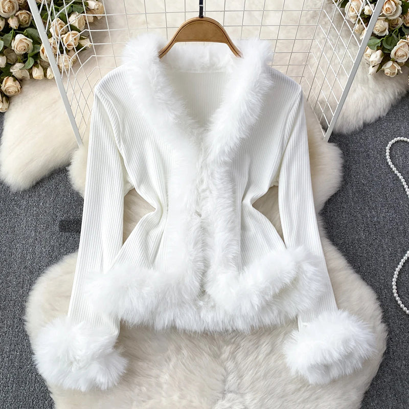 Women's elegant ribbed top with plush faux fur trim on neckline, cuffs, and hem