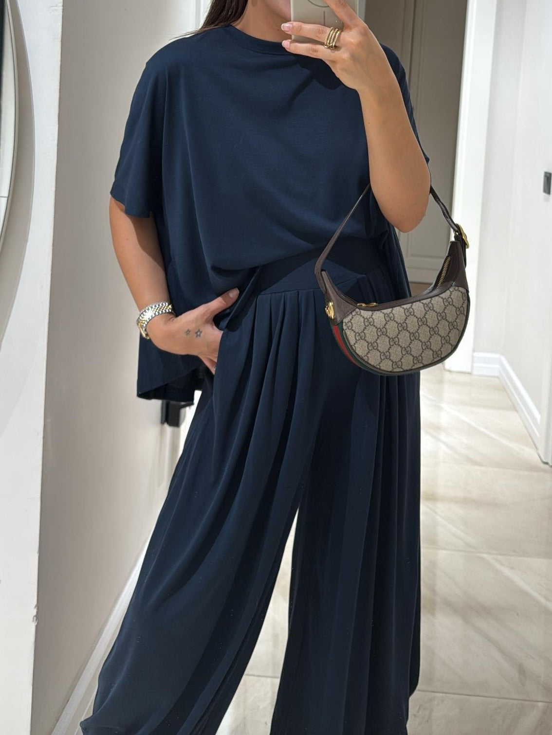 Casual two-piece set featuring relaxed top and wide-leg pants with soft flowing drape