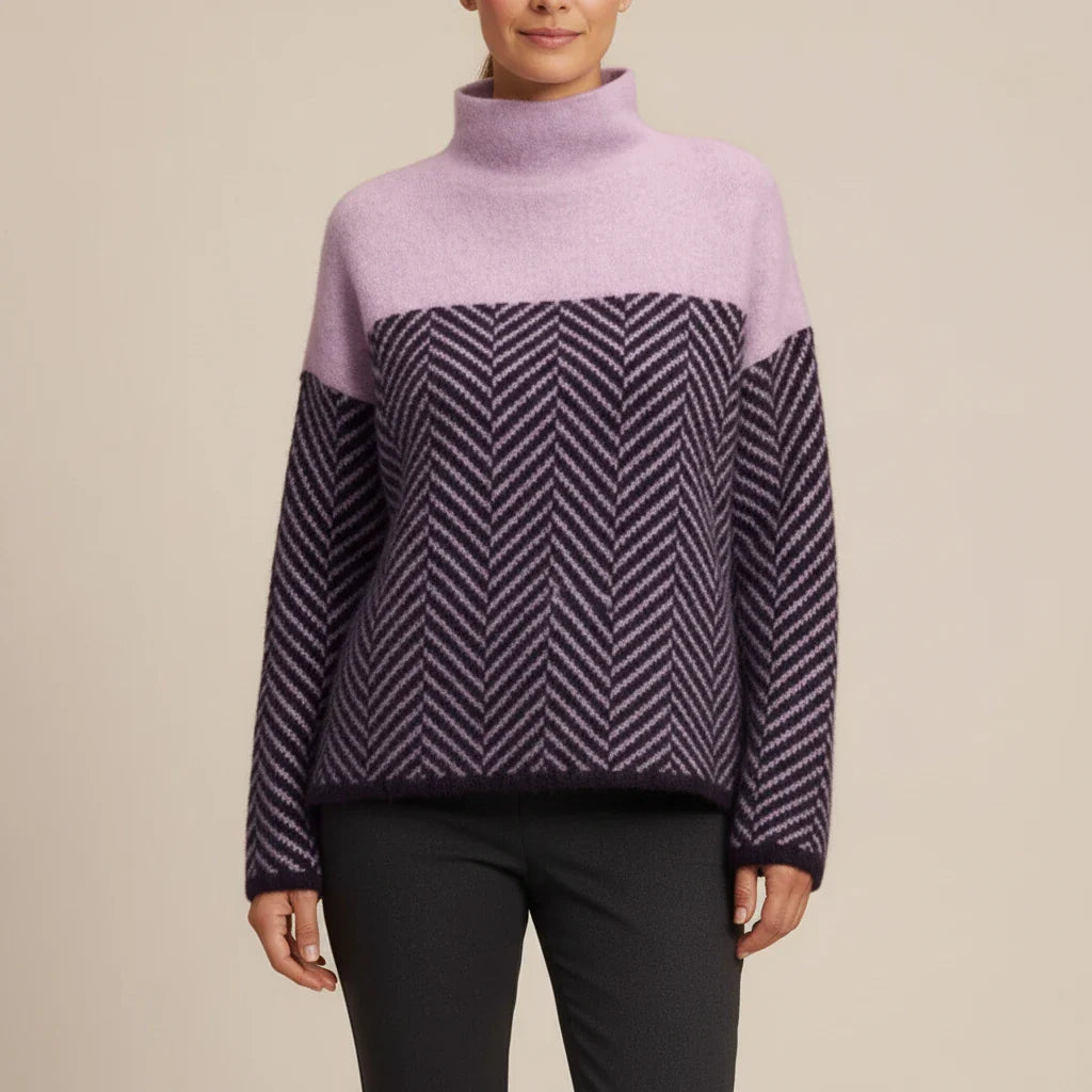 Women's oversized color block turtleneck sweater with bold chevron pattern in cool-weather style