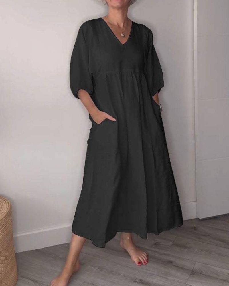 Elegant black maxi dress with deep V-neck and flowing silhouette for summer occasions