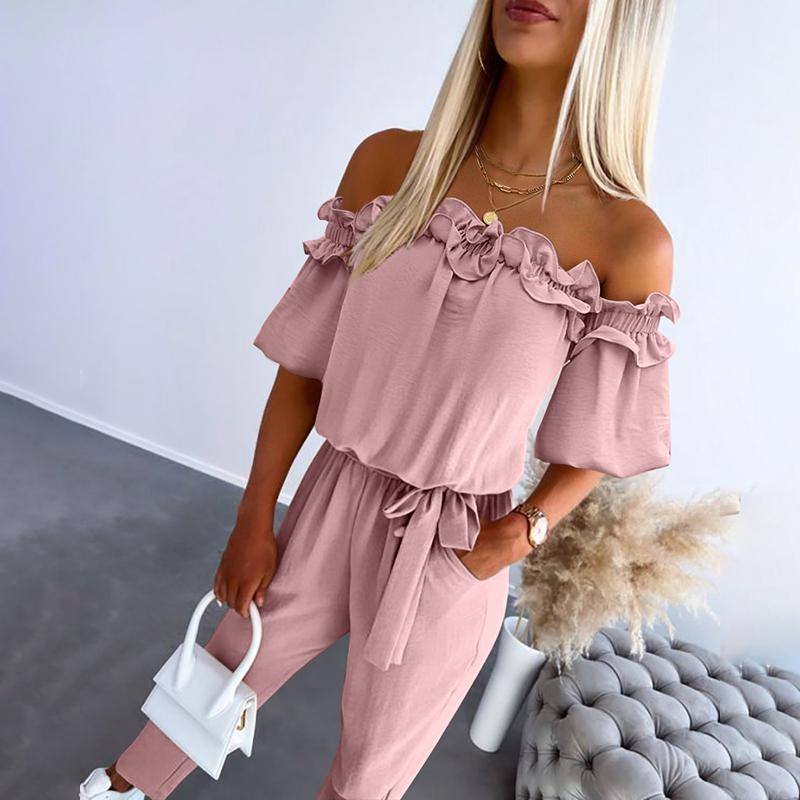 Black off-shoulder frill jumpsuit with tie-waist cinching silhouette, feminine chic style