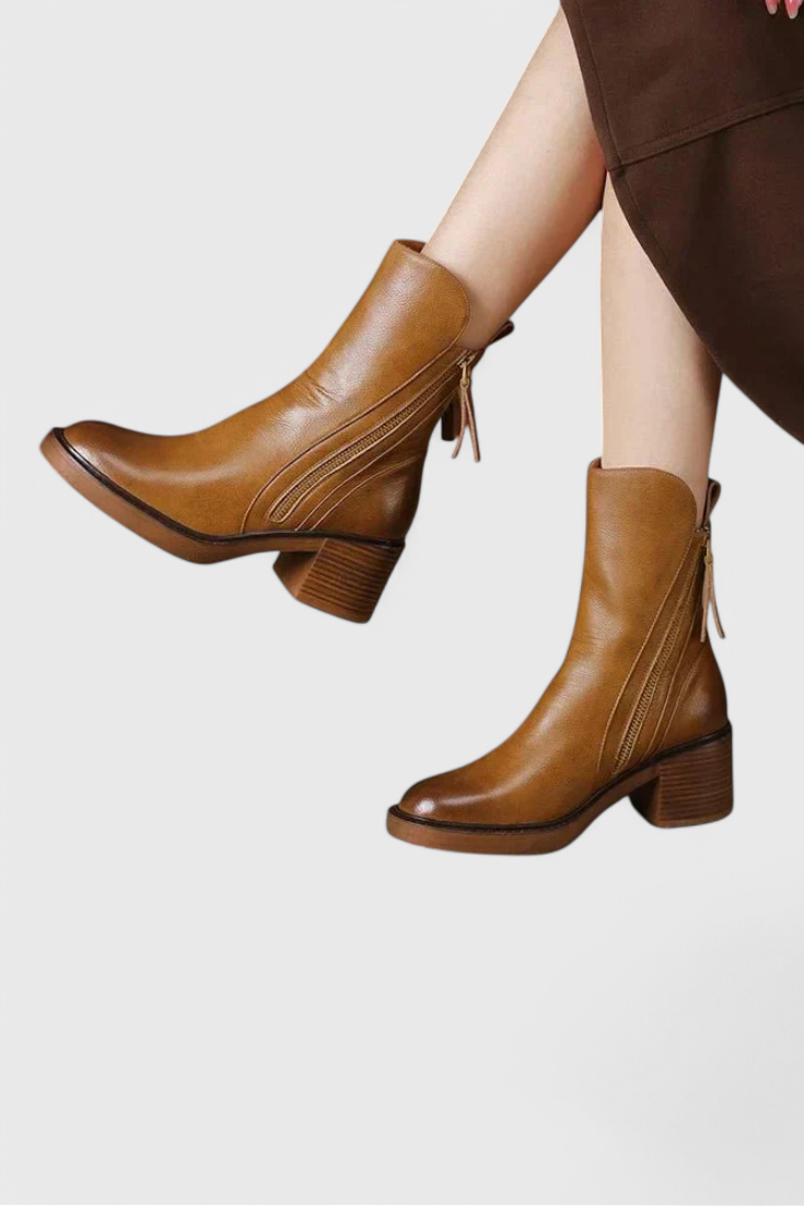 Black sleek ankle boots with streamlined silhouette and leg-lengthening ankle-height cut