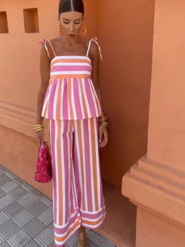 Flowy layered women's wedding guest dress in light hues, structured silhouette smoothing the midsection