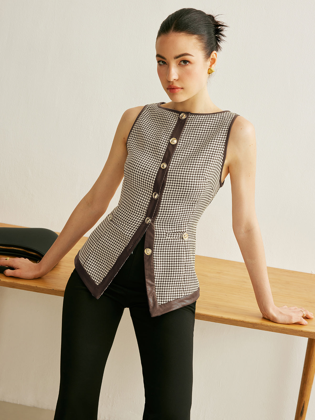 Black white houndstooth sleeveless vest with contrast trim and metal button closure