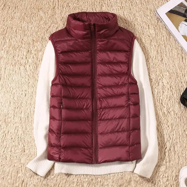 Women's slim lightweight sleeveless puffer vest for cold weather layering, insulated zip-front design