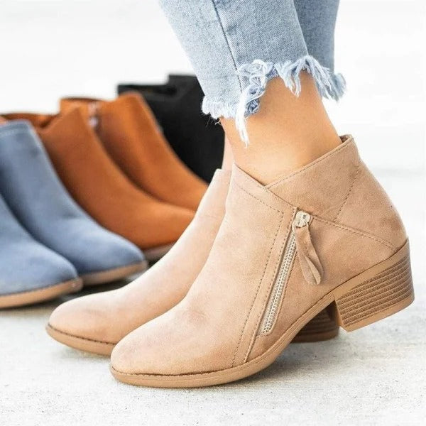 Black orthopedic heel boots with structured silhouette and anatomical triple-arch support insole
