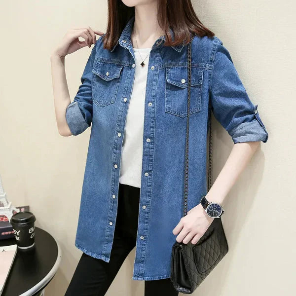 Women's slim fit denim shirt with button front closure and dual chest pockets, medium length