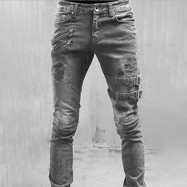 Men's slim fit distressed blue denim jeans with gothic buckle accents and zipper detail