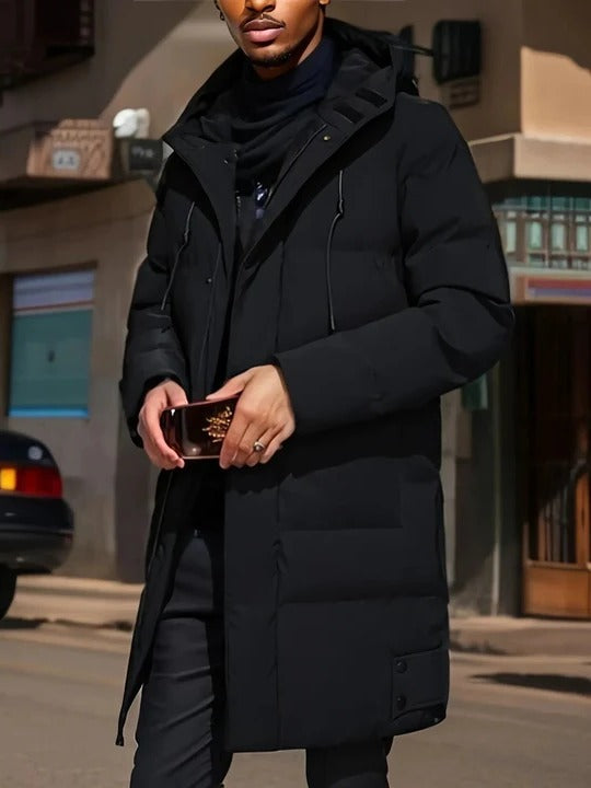 Men's long black puffer coat with hood, zip closure, and extended silhouette for cold-weather layering